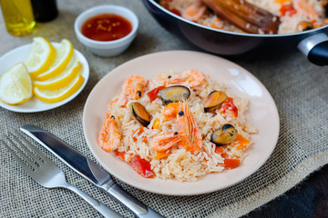 Spanish dish paella with seafood, shrimps in pan
