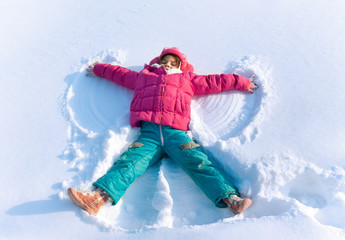 Little child playing in snow