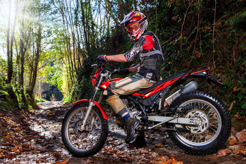 Fototapeta na wymiar Motocross rider with bike in dirt track.