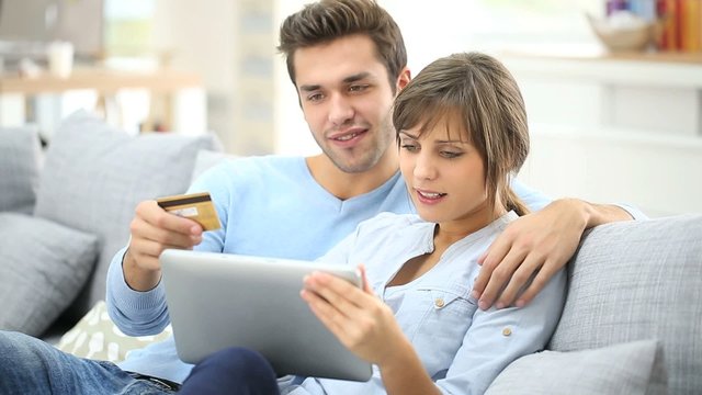 Young couple shopping on internet with tablet