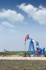two oil pump jack on oilfield