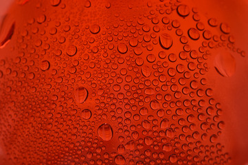close up shot of water drops on glass surface as background.