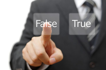 businessman choose virtual button with false word instead true
