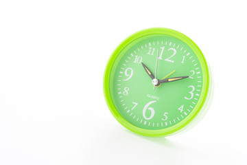 Green clock isolated on white background