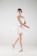 Ballet dancer in white tutu posing