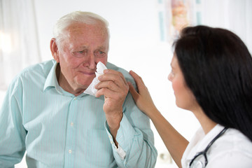 Doctor talking to her male senior patient at office