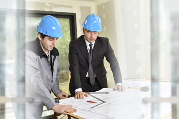 Engineer on building site with construction worker
