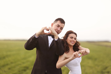 Wedding shot of bride and groom on field