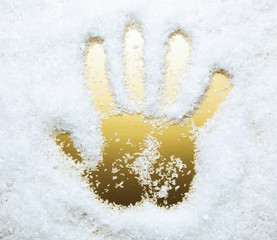 Hand print in artificial snow, golden color