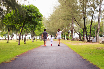 Family walking at park in the morning