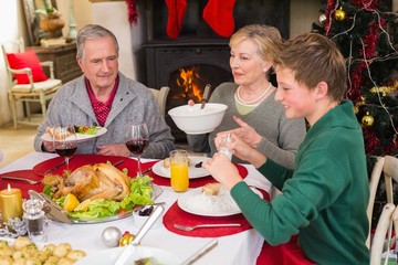 Smiling extended family at the christmas dinner table