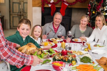 Man serving roast turkey at christmas