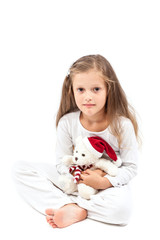 Little cute girl with Christmas bear in hands.