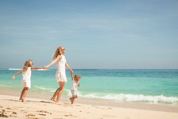Happy family playing at the beach in the day time