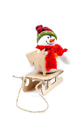 Snowman on a sled with Christmas tree on a white background.