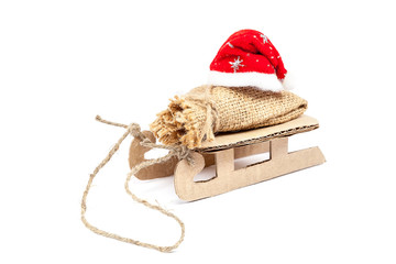 Sleigh with a sack and a Santa Claus hat.