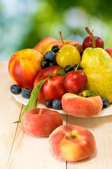 different fruits on green background closeup