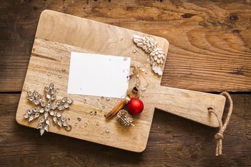 Blank card on cutting board with christmas decorations