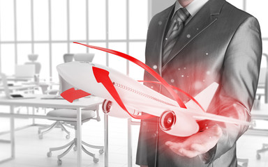Businessman with airplane over his hand
