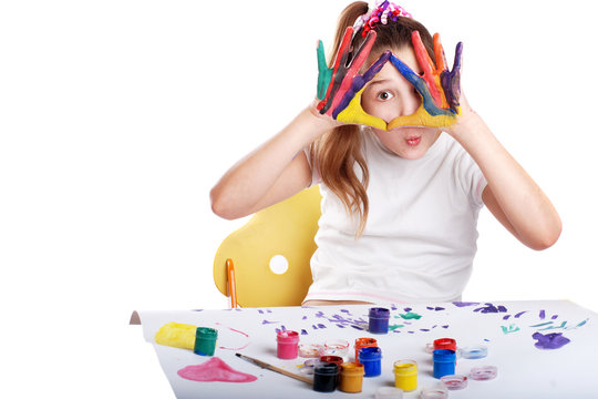 cheerful girl showing her hands painted in bright colors