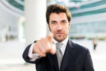 Businessman pointing his finger at you