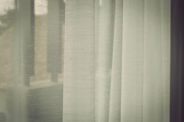 White curtain beside window