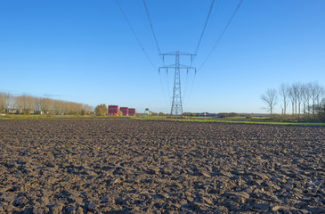 Transmission tower under a sunny sky at fall