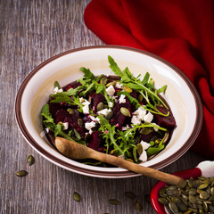 Beetroot salad with arugula, feta cheese and pumpkin seeds