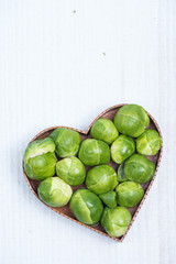 heart shape with fresh green broccoli on white table