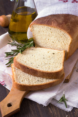 Bread with rosemary and olive oil on a wooden table