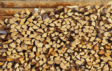 Birch firewood. Wooden background