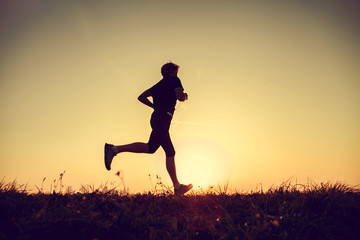 Running man silhouette in sunset time