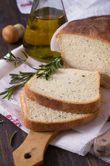 Bread with rosemary and olive oil on a wooden table