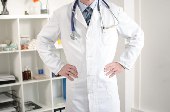Doctor standing with hands on hips