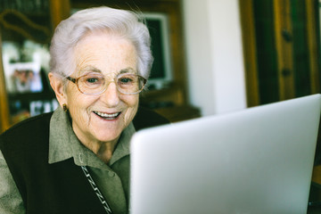 Fototapeta na wymiar Senior woman with laptop at home