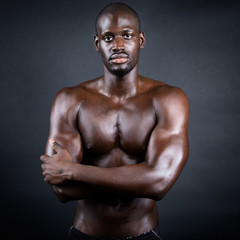 Fototapeta na wymiar Beautiful and muscular man in dark background.