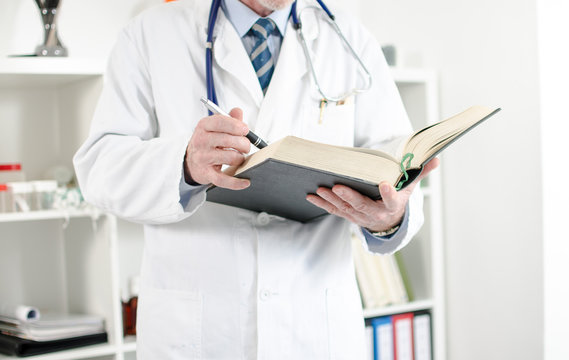 Doctor reading a medical book