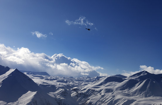 Helicopter above snowy plateau