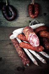 several types of sausages on a wooden background