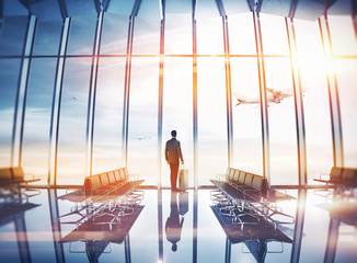 Businessman at airport with suitcase