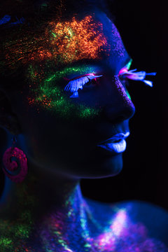 Sensual woman in fluorescent paint makeup