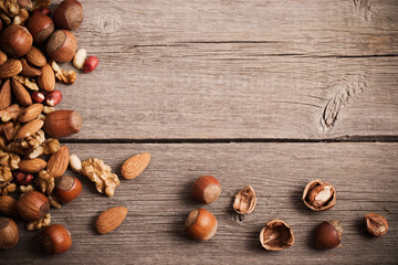 Mixed nuts on  old wooden background