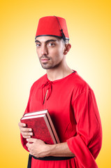 Young turk with book on white