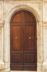 Fototapeta na wymiar The old wooden door seen in Siena. Tuscany. Italy