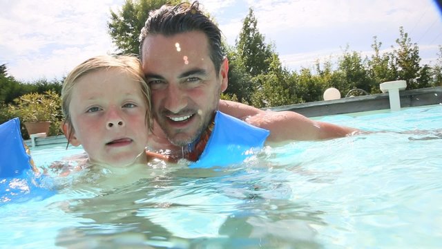 Father and son in swimming pool