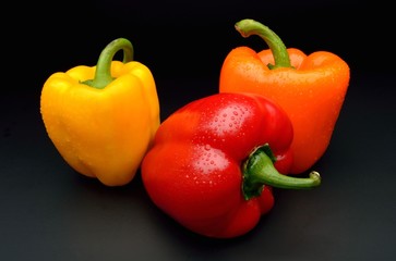 Colored peppers isolated on black background