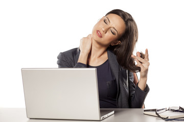 young beautiful businesswoman has a pain in the neck