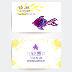 Business card layout with fish, star and yellow splashes.