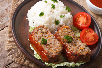meat loaf with rice on a plate on a table