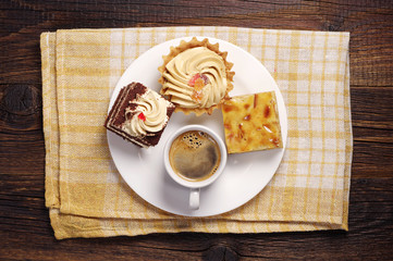 Three cakes and coffee cup